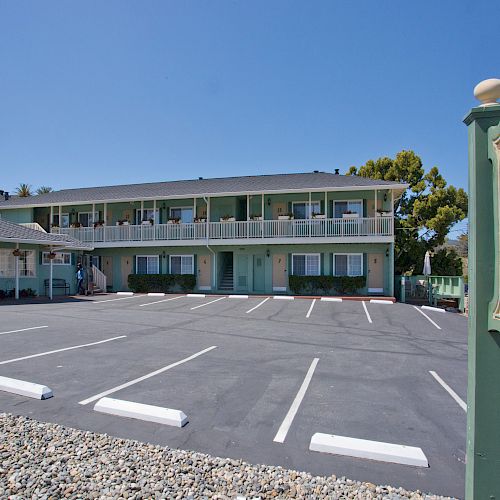 This image shows a two-story inn with a green sign reading 